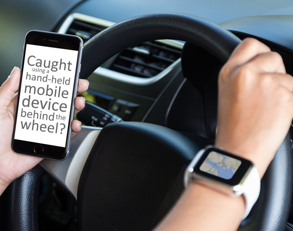 Is it possible to use a cell phone while driving in Manitoba?