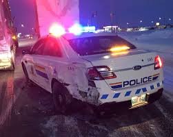 Police cruiser rear-ended by passing semi