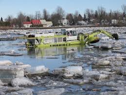 Unusual amphibious excavators break river ice in Manitoba